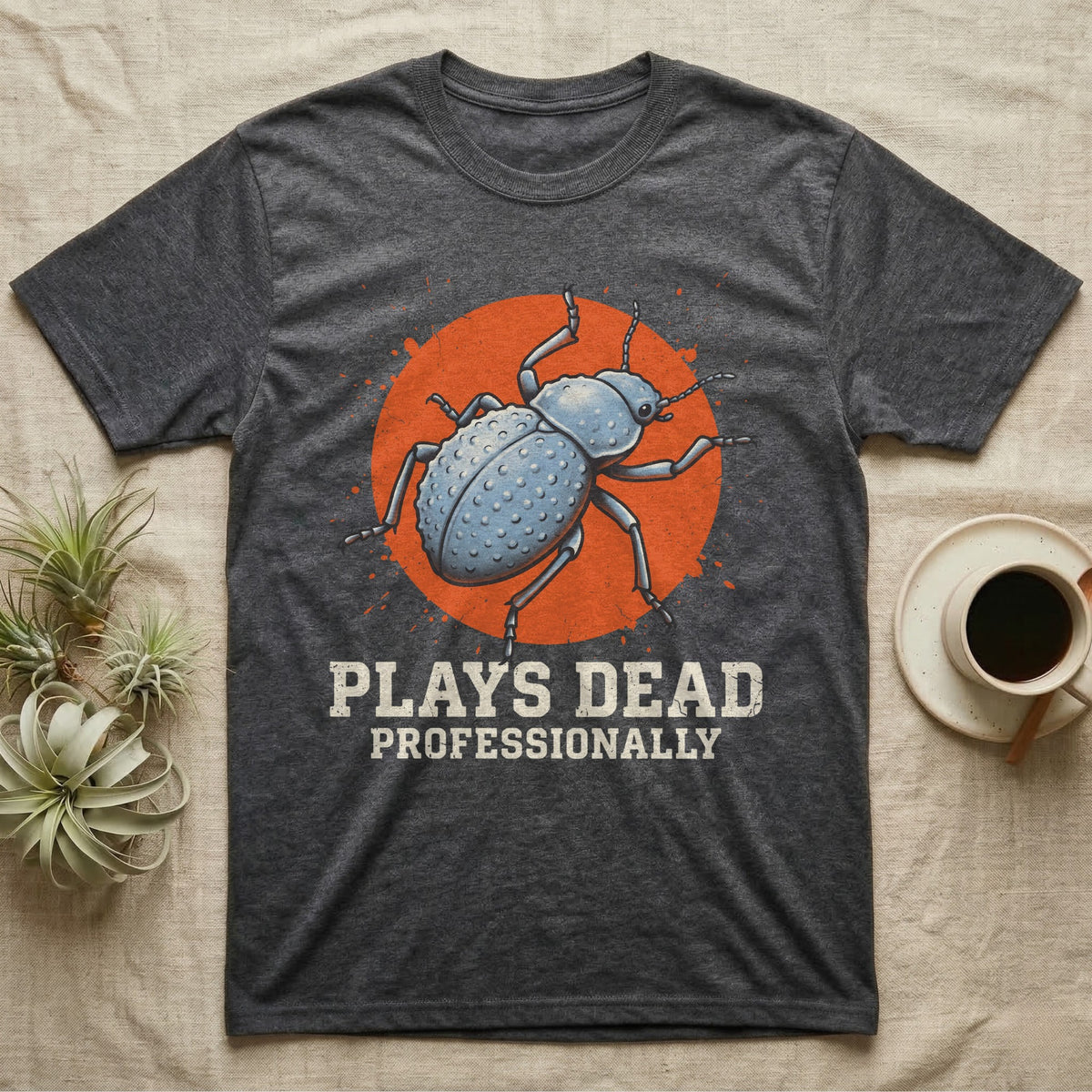 Blue Death Feigning Beetle T-Shirt in Dark Heather — Distressed disc portrait of a blue death-feigning beetle over an orange circle with text plays dead