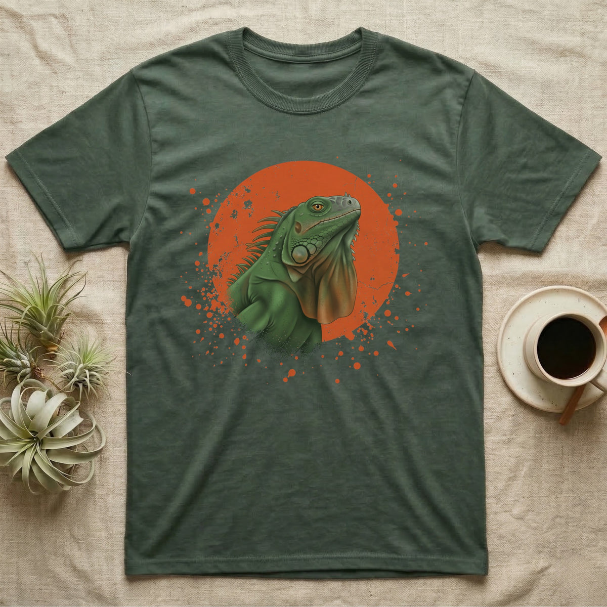 Green Iguana Stink Face T-Shirt in Military Green — Distressed vintage-style illustration of a green iguana with its dewlap fully dropped and chin lifted, on an orange disc.