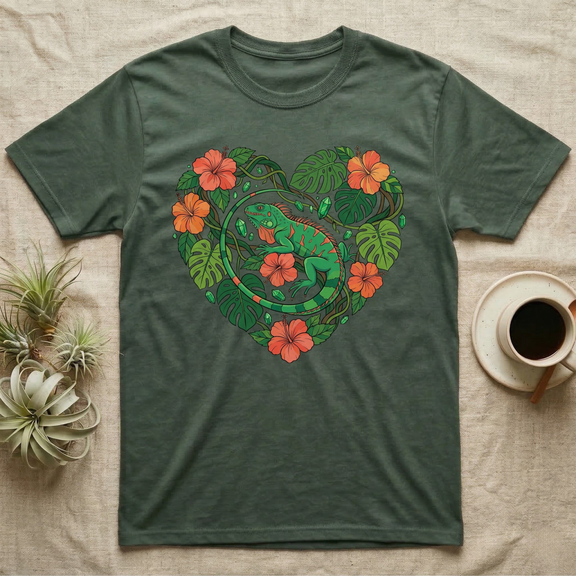 Green t-shirt with a heart design featuring an iguana and tropical flowers.