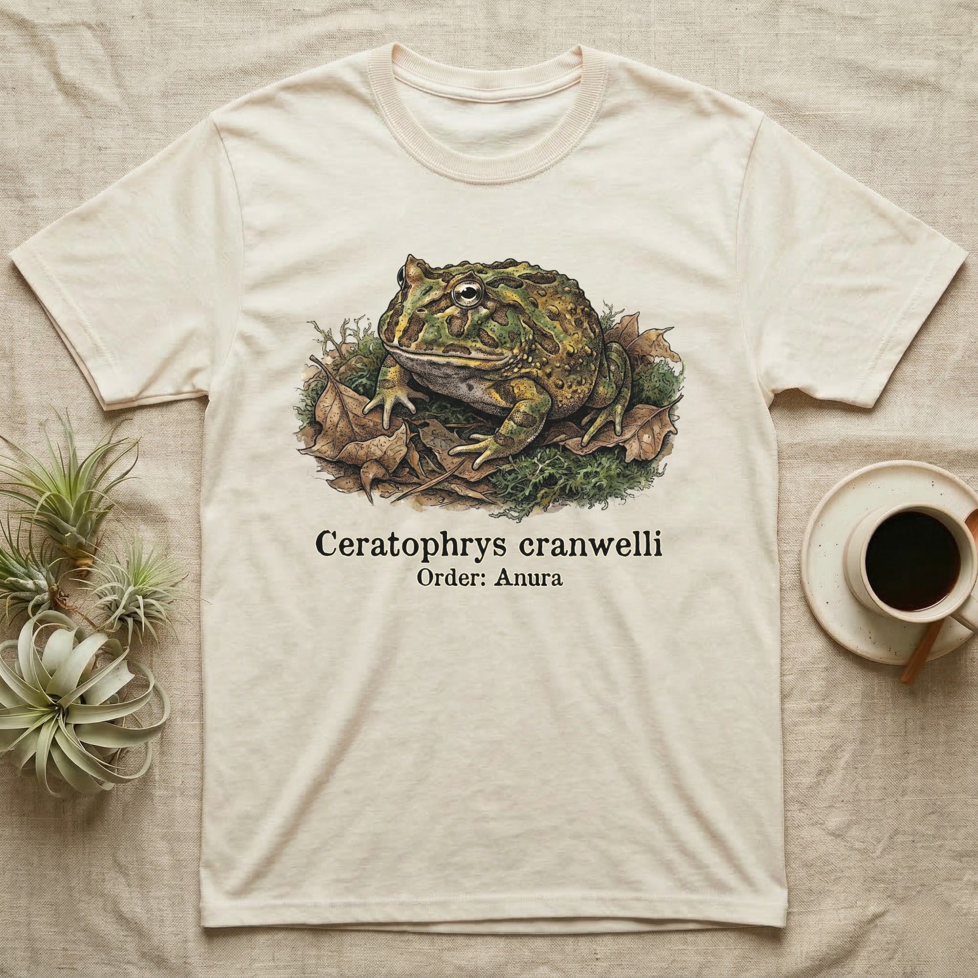Cream t-shirt with illustration of a Pacman frog and text "Ceratophrys cranwelli Order: Anura".