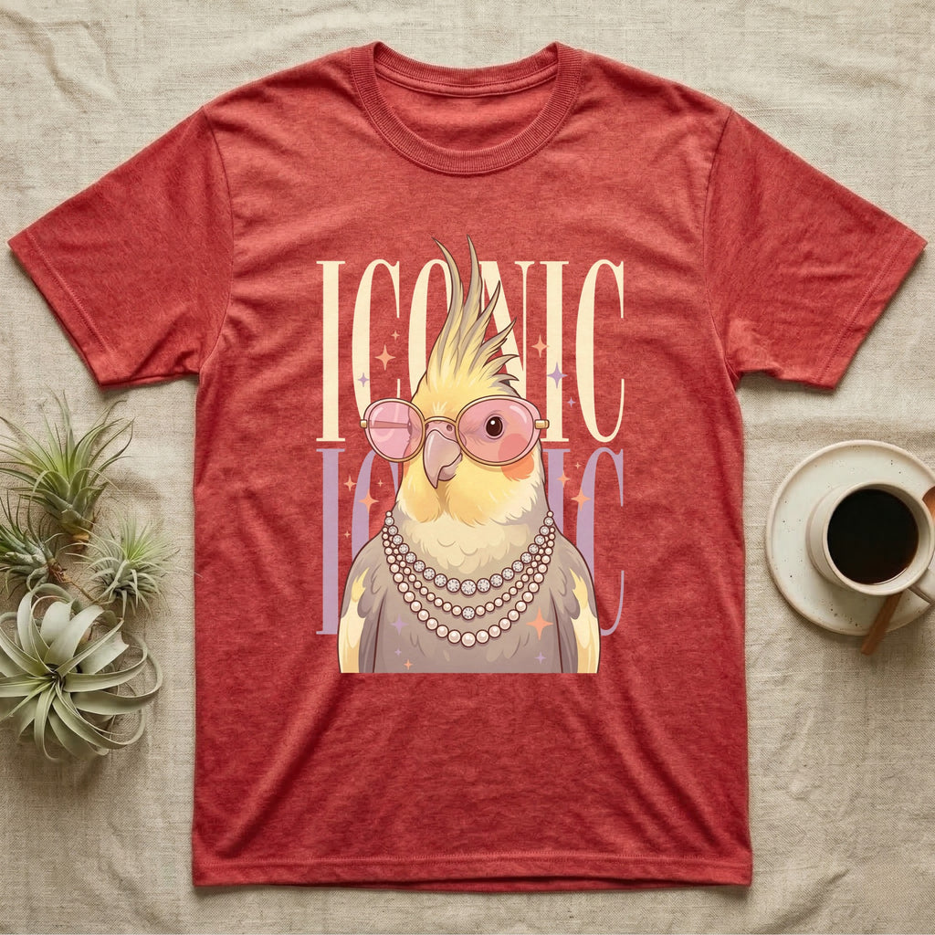 Cockatiel wearing pearls and sunglasses on a red t-shirt.