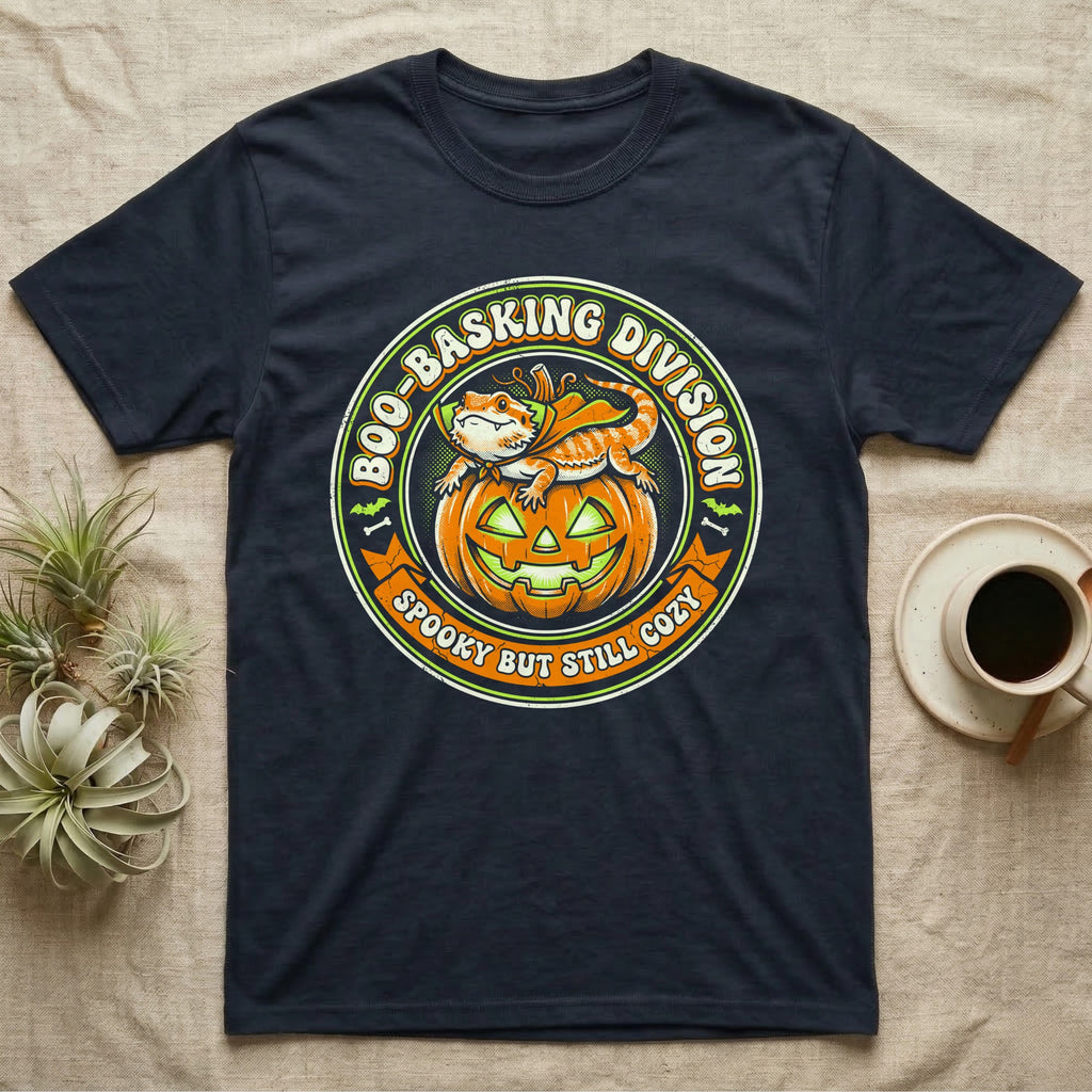 Bearded Dragon Boo-Basking T-Shirt in Navy — Retro badge of a caped bearded dragon on a green-glowing pumpkin, "Boo-Basking Division, Spooky But Still Cozy."