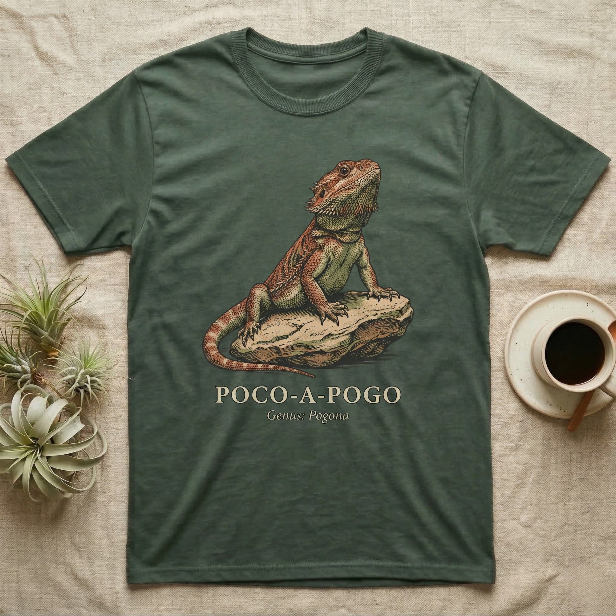 Green t-shirt with a bearded dragon on a rock, text reads "Poco-A-Pogo".