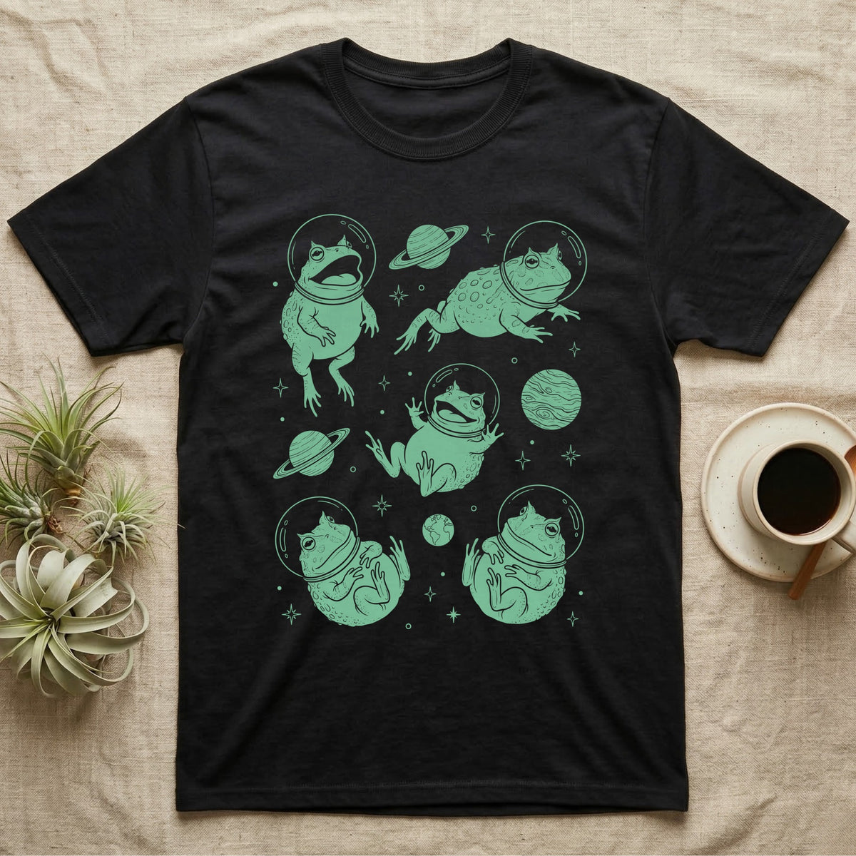 Pacman Frog Cosmic T-Shirt in Black — Vintage screen-print illustration of Pacman frogs in astronaut helmets floating in space, cosmic jade green monochromatic on dark background.