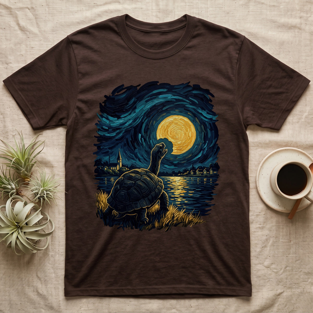 Hermann's Tortoise Moon T-Shirt in Dark Chocolate — Painted Hermann's tortoise seen from behind, neck stretched up, biting a piece out of a golden spiral moon in a swirling blue night sky over a lake