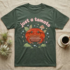 Tomato Frog Softie T-Shirt in Military Green — Round red-orange tomato frog facing forward under a puffy pastel "just a tomato" bubble wordmark with tiny hearts.