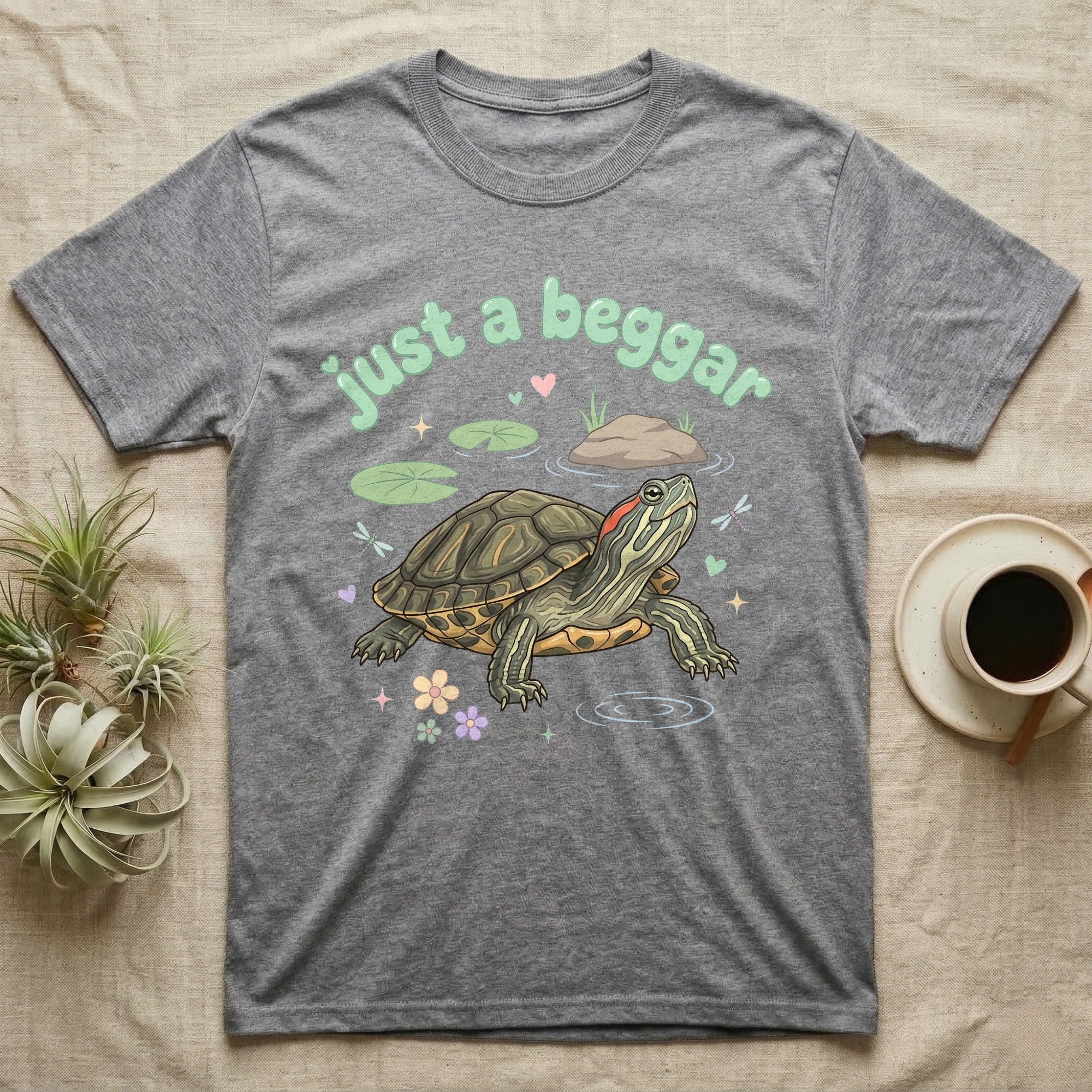 Red-Eared Slider Softie T-Shirt in Sport Grey — Red-eared slider turtle stretching its neck to beg, under pastel bubble text "just a beggar" with hearts.