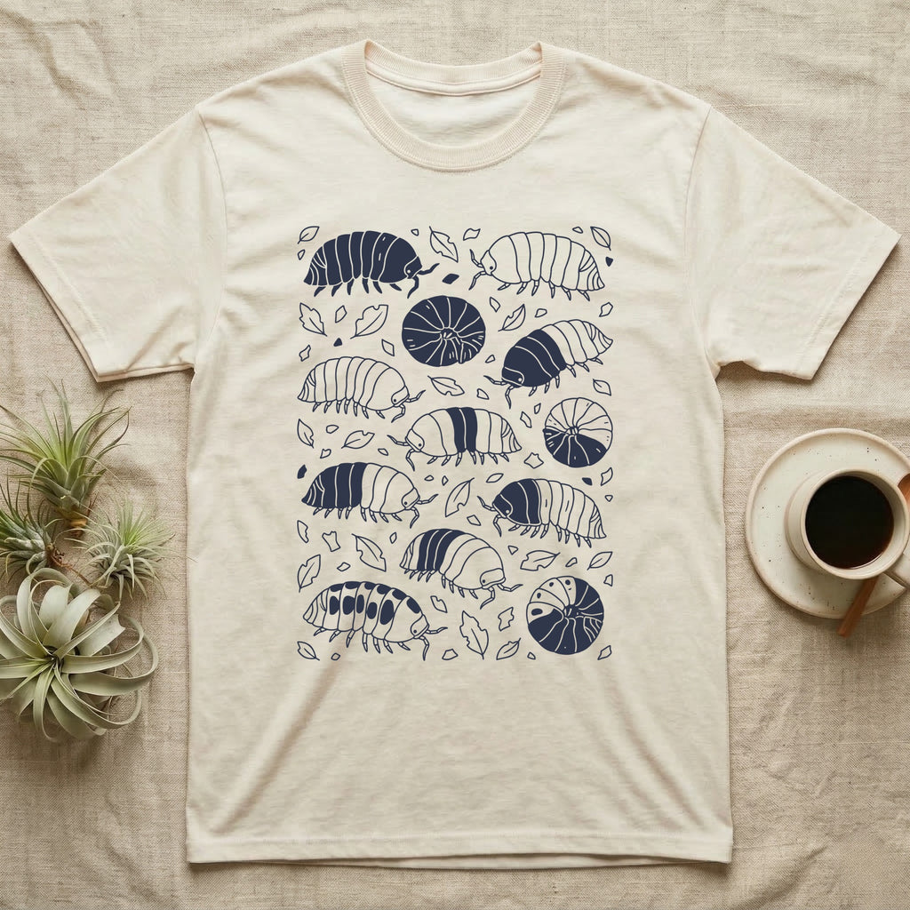 Cubaris Isopod Morph Collection T-Shirt in Natural — Deep navy single-ink illustration of Cubaris isopods in varied morph patterns scattered across leaf litter.