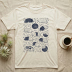 Cubaris Isopod Morph Collection T-Shirt in Natural — Deep navy single-ink illustration of Cubaris isopods in varied morph patterns scattered across leaf litter.