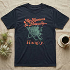 African Bullfrog Sun Lounger T-Shirt in Navy — Illustrated African bullfrog reclining in a beach chair with sunglasses and a cocktail, retro coral script reading My Humour Is Naturally Hungry.