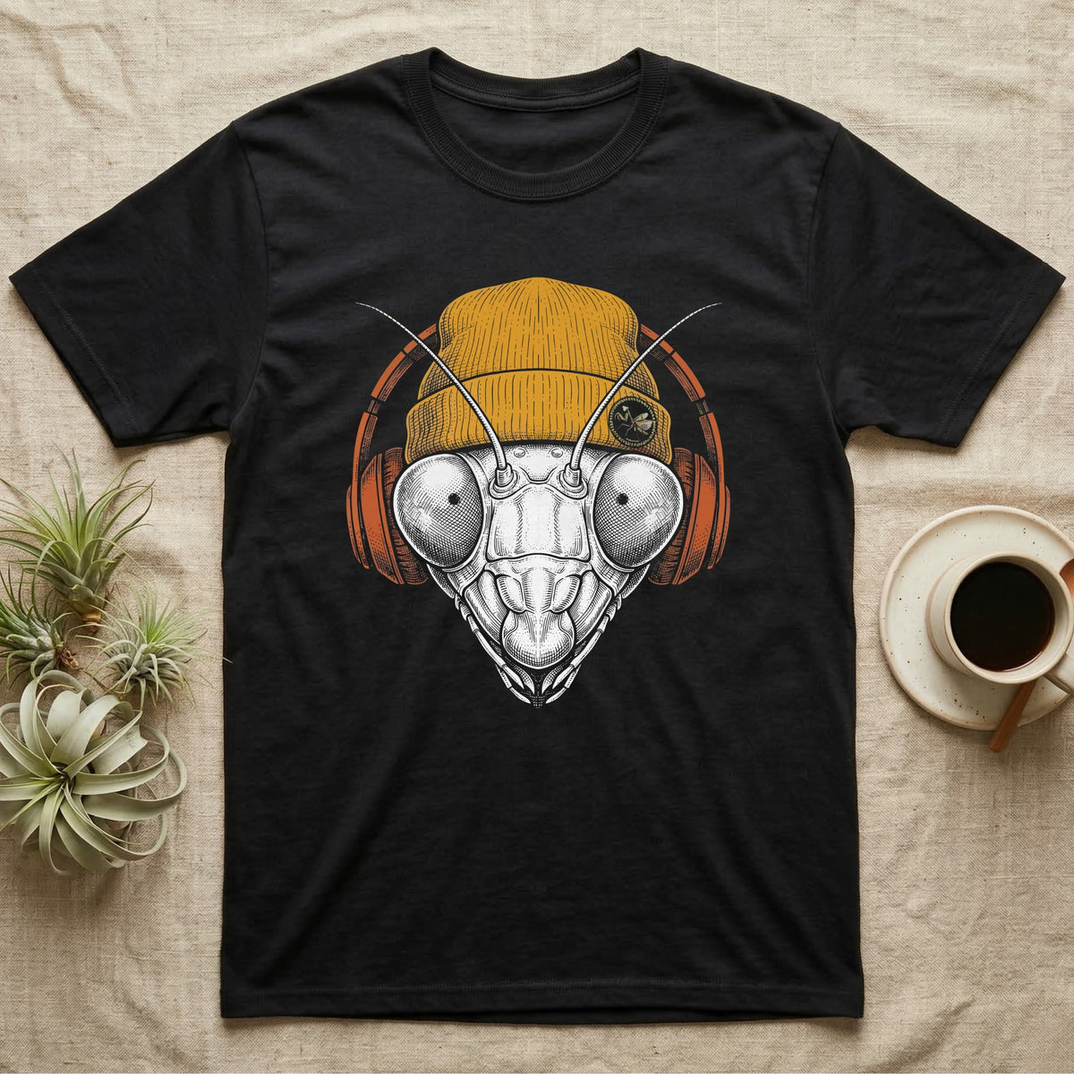 Praying Mantis Chill Beats T-Shirt in Black — Engraved praying mantis with large compound eyes and antennae, wearing a knit beanie and over-ear headphones.