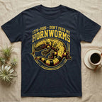 Gila Monster Hornworms Tee in Navy — Bold gold and maroon woodcut tee of a Gila monster with banded tail, large text reading Don't Feed Me Hornworms, on black.