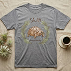 Sulcata Tortoise Salad Love T-Shirt in Sport Grey — Sepia watercolour illustration of a Sulcata tortoise mid-bite inside a salad-greens wreath with "SALAD" lettering.