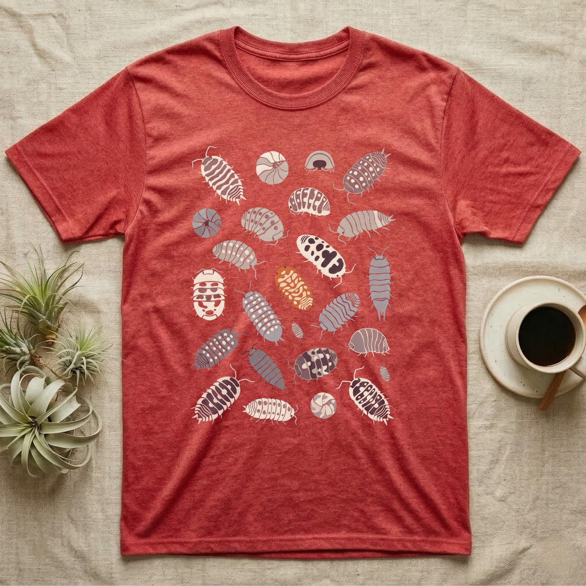 Isopod Morph Plate T-Shirt in Heather Red — About twenty-five flat-painted isopods scattered across grey, all shapes and patterns, one of them orange.