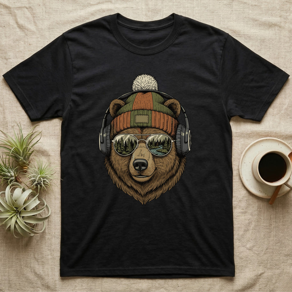 Bear wearing headphones and beanie, with forest and mountains reflected in sunglasses.