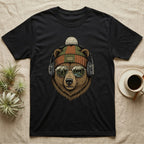 Bear wearing headphones and beanie, with forest and mountains reflected in sunglasses.