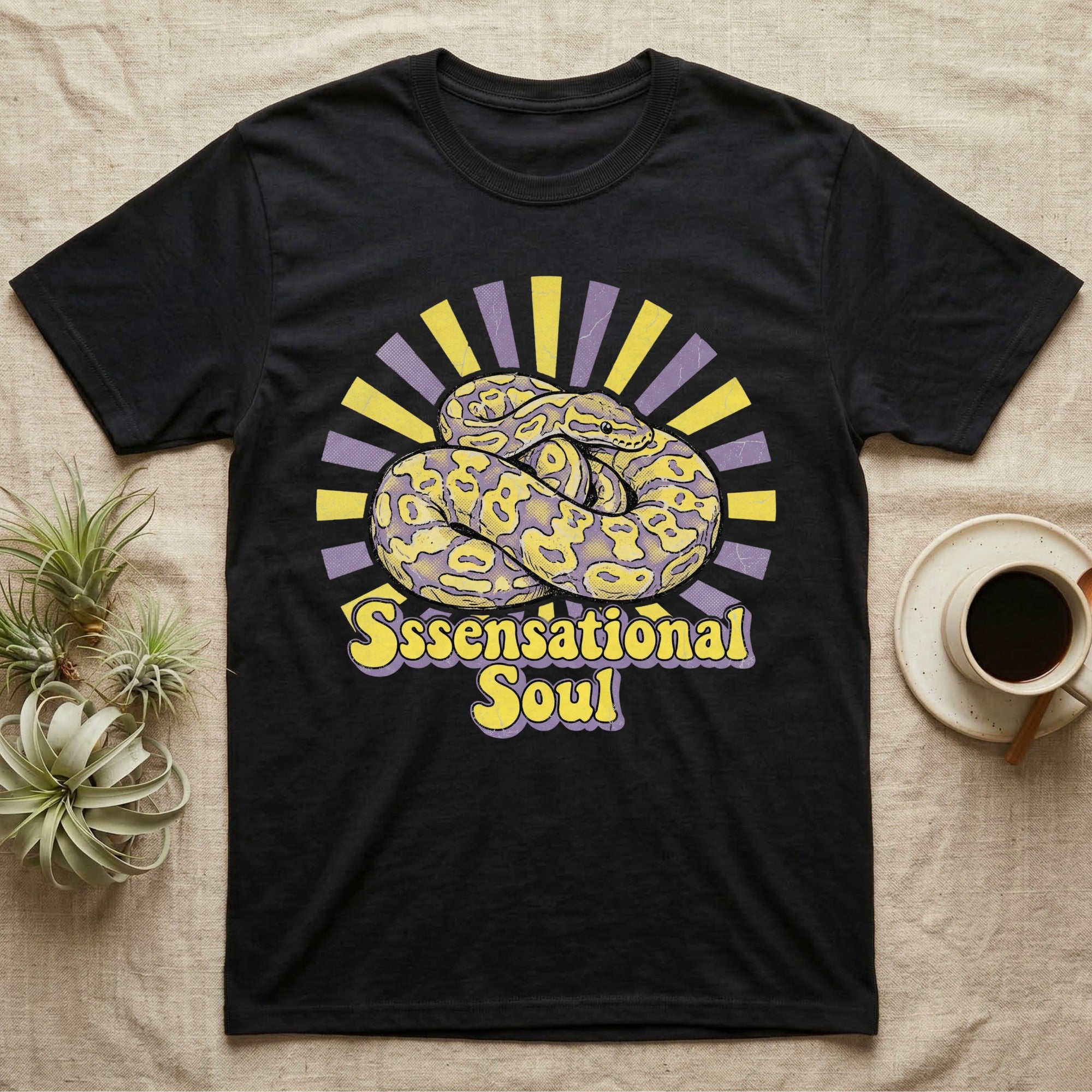 Black t-shirt with yellow and purple rays and a coiled snake graphic.