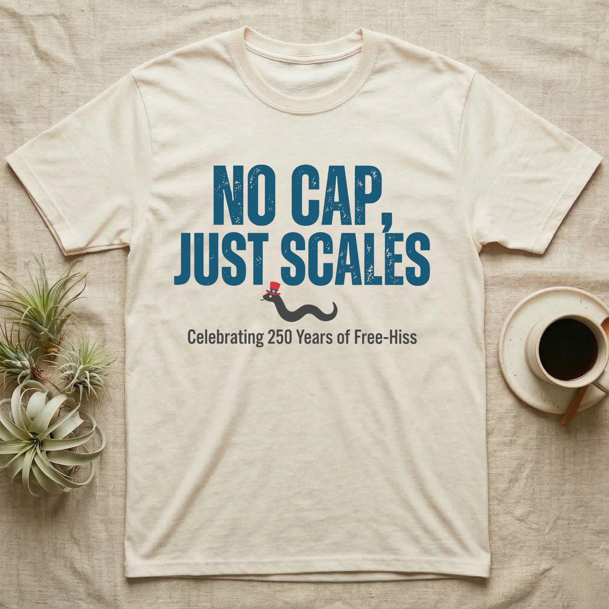 Rattlesnake No Cap T-Shirt in Natural — Big distressed text No Cap Just Scales over a tiny snake in a red top hat with 250 Years of Free-Hiss below.