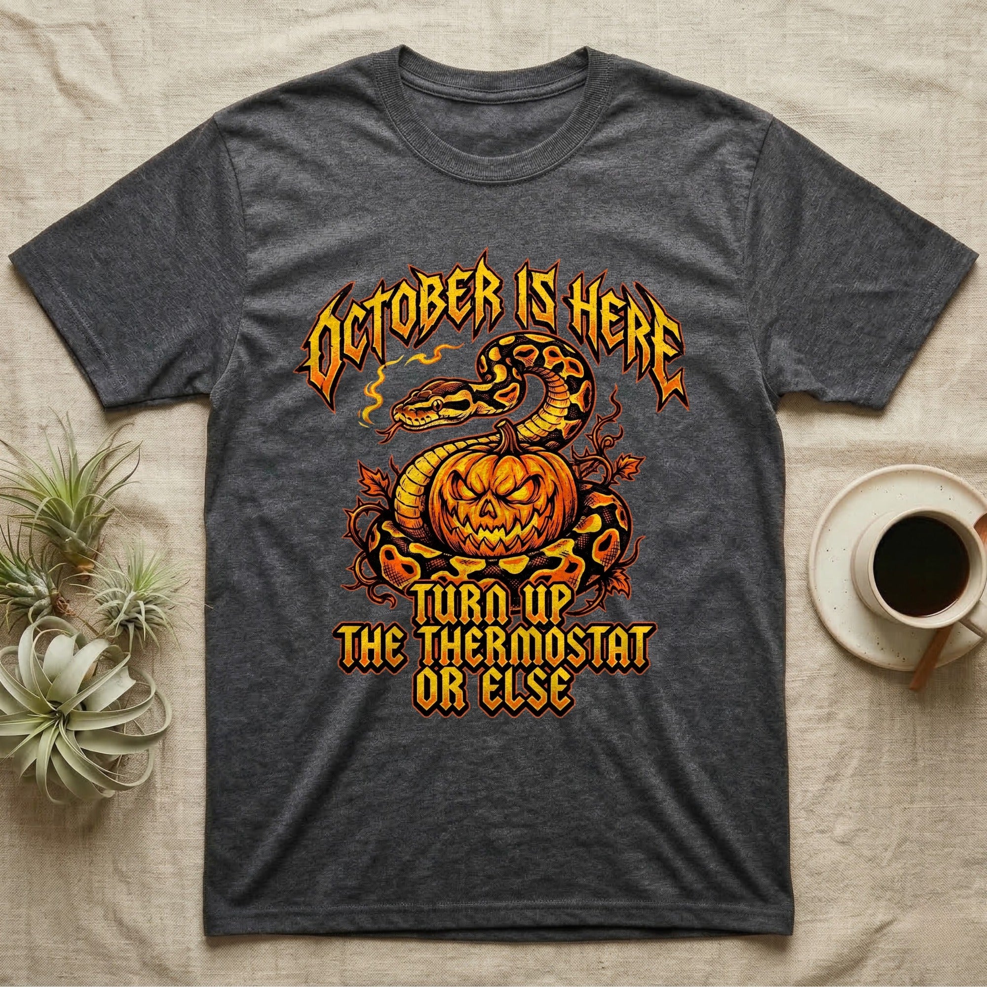 Ball Python October Thermostat T-Shirt in Dark Heather — Metal-band style ball python coiled over a glowing jack-o'-lantern, "October Is Here, Turn Up the Thermostat Or Else."