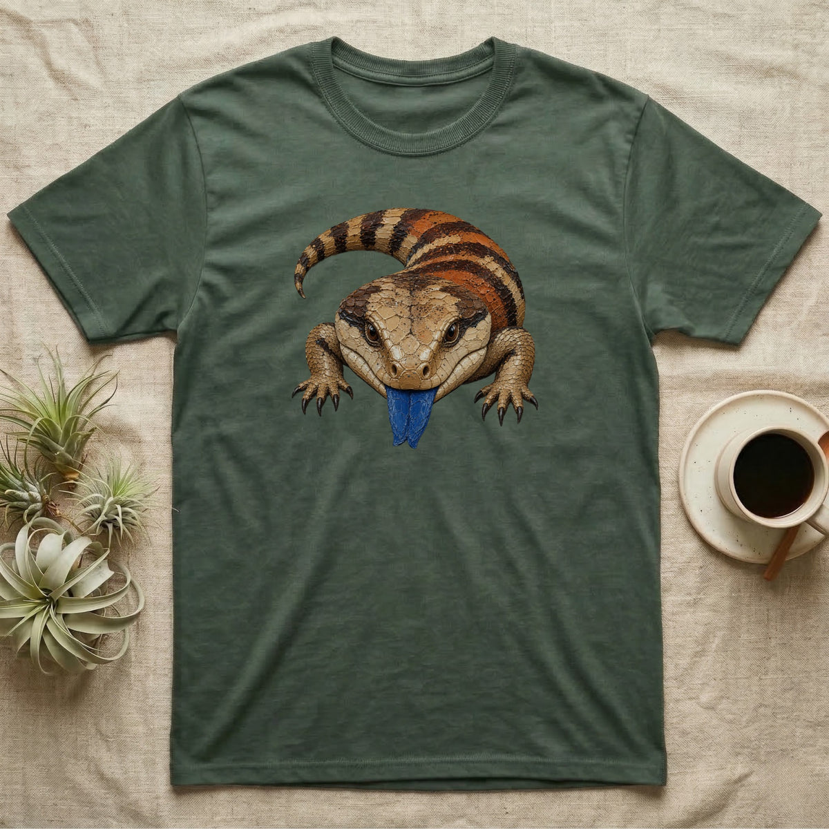 Blue-tongued skink illustration on a dark green t-shirt.