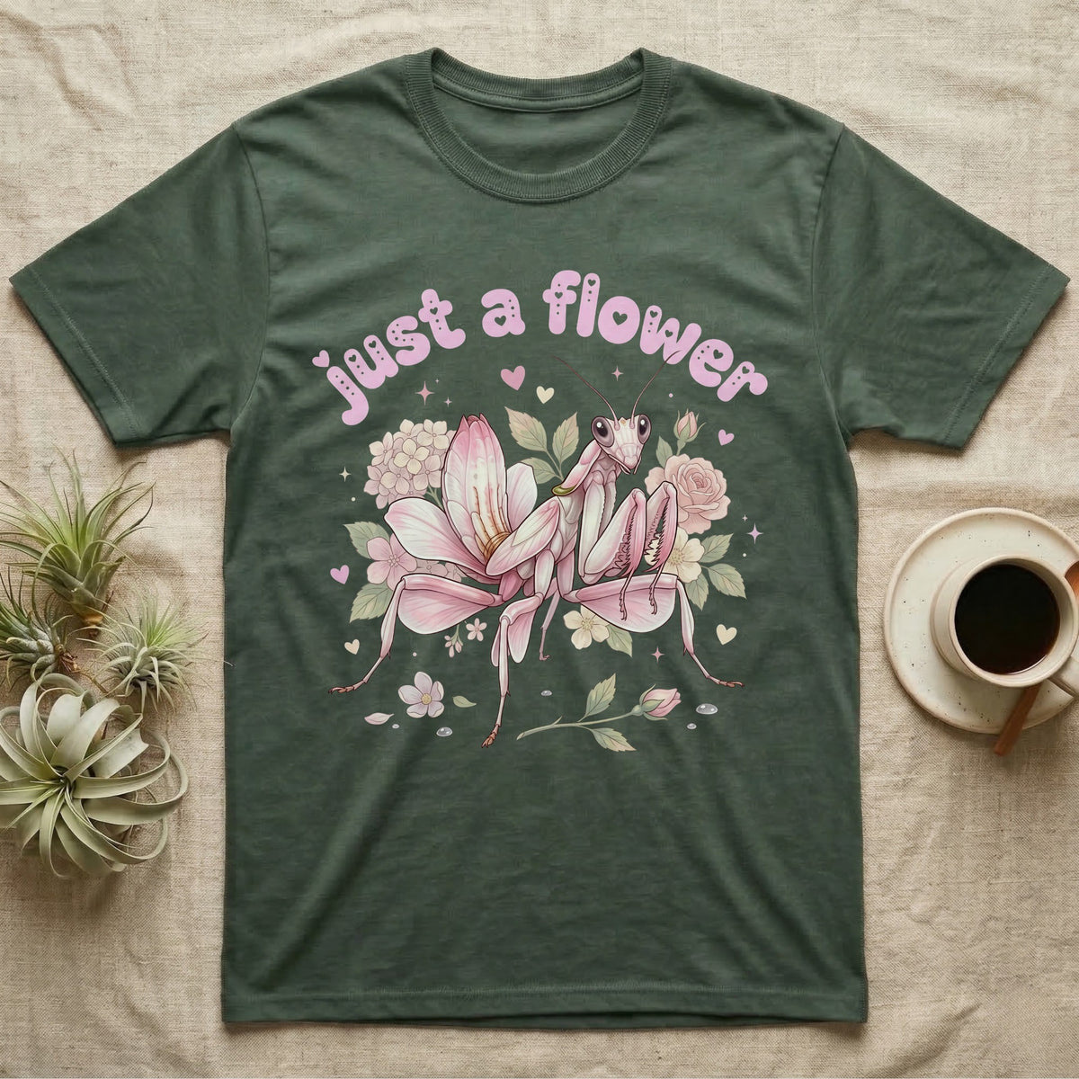 Orchid Mantis Softie T-Shirt in Military Green — Pink orchid mantis mimicking a flower under pastel bubble text "just a flower" with tiny hearts.