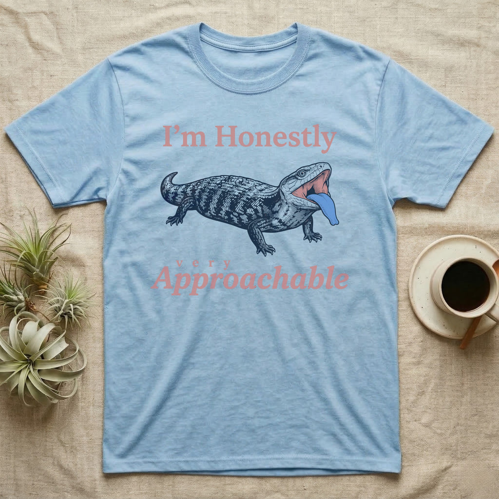 Blue-Tongued Skink Hiss T-Shirt in Light Blue — Navy engraving of a hissing blue-tongued skink with its bright blue tongue out between the words I'm Honestly and very Approachable