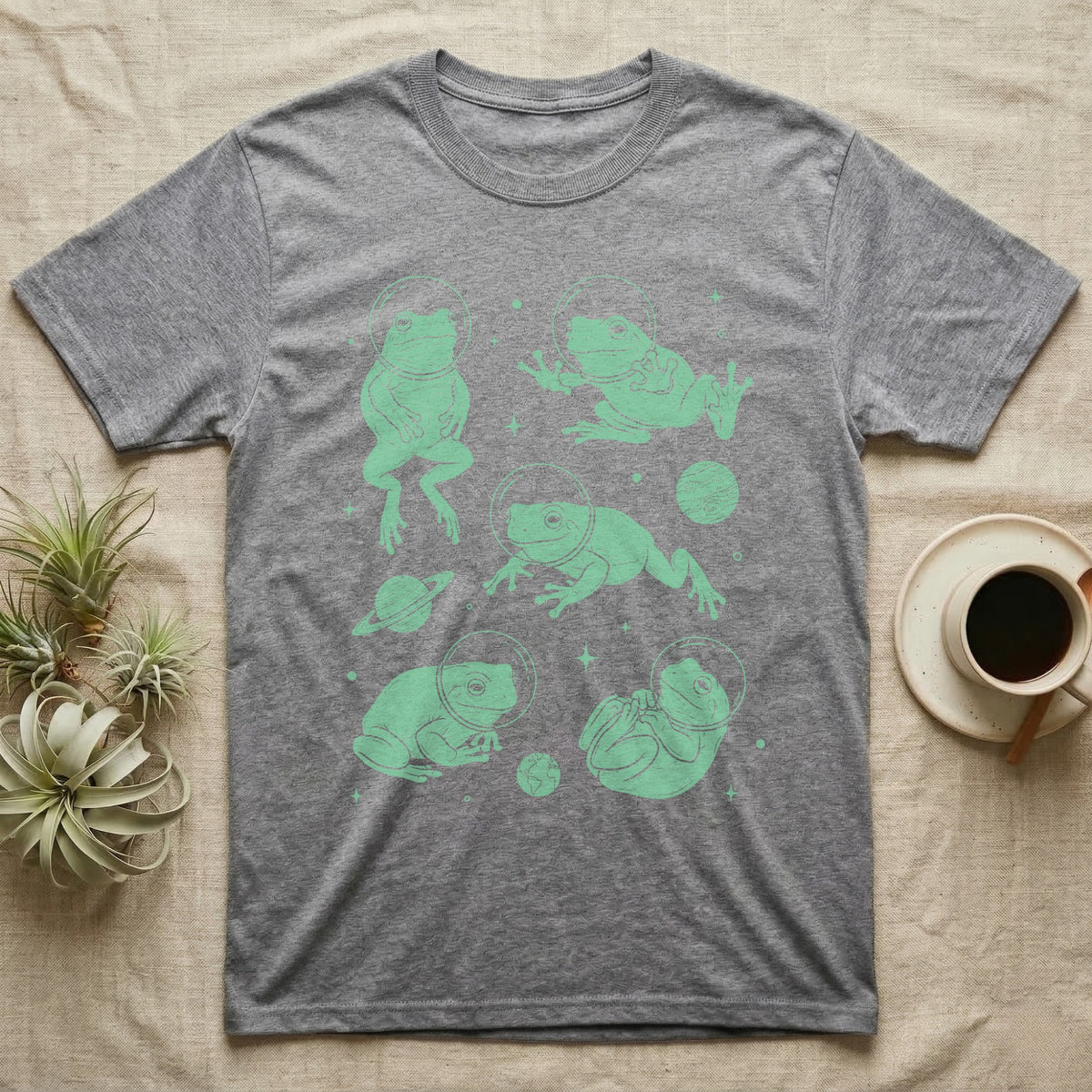Whites Tree Frog Cosmic T-Shirt in Sport Grey — Vintage screen-print illustration of White's tree frogs in astronaut helmets floating in space, cosmic jade green monochromatic on dark background.
