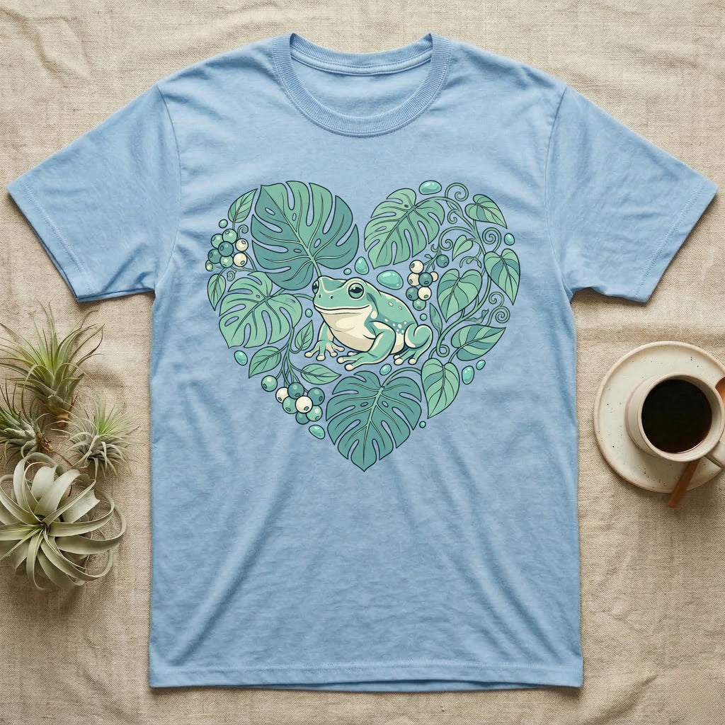 Blue t-shirt with a green frog in a heart-shaped arrangement of leaves.