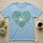 Blue t-shirt with a green frog in a heart-shaped arrangement of leaves.