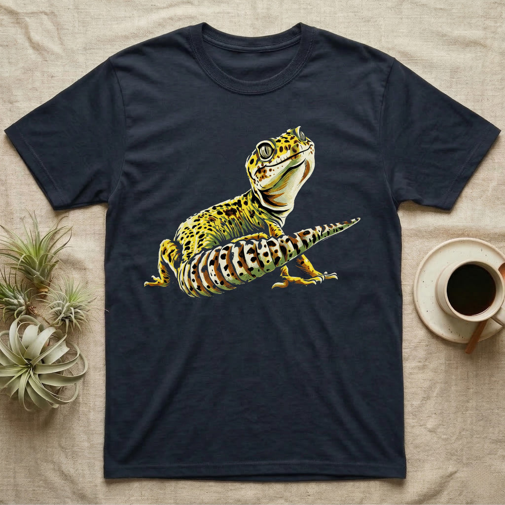 Illustration of a smiling leopard gecko with a plump curled spotted tail, bold vintage-comic ink outlines and halftone shading, graphic-only, no text. — shown on a Navy tee.