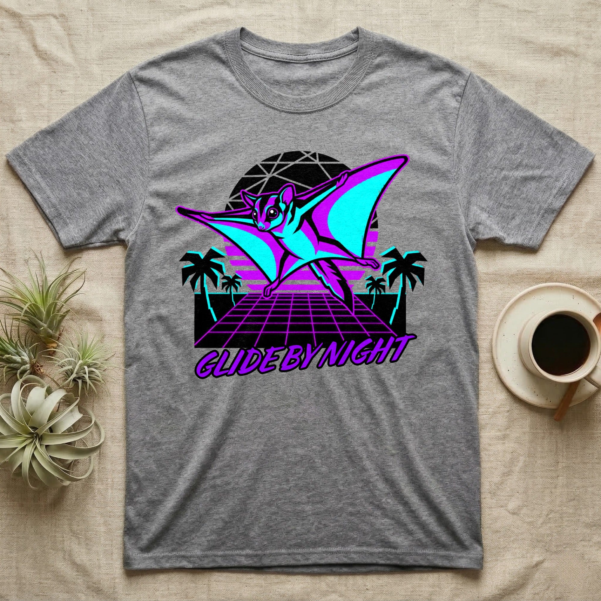 Gray t-shirt with neon pink and blue flying squirrel graphic and "Glide by Night" text.