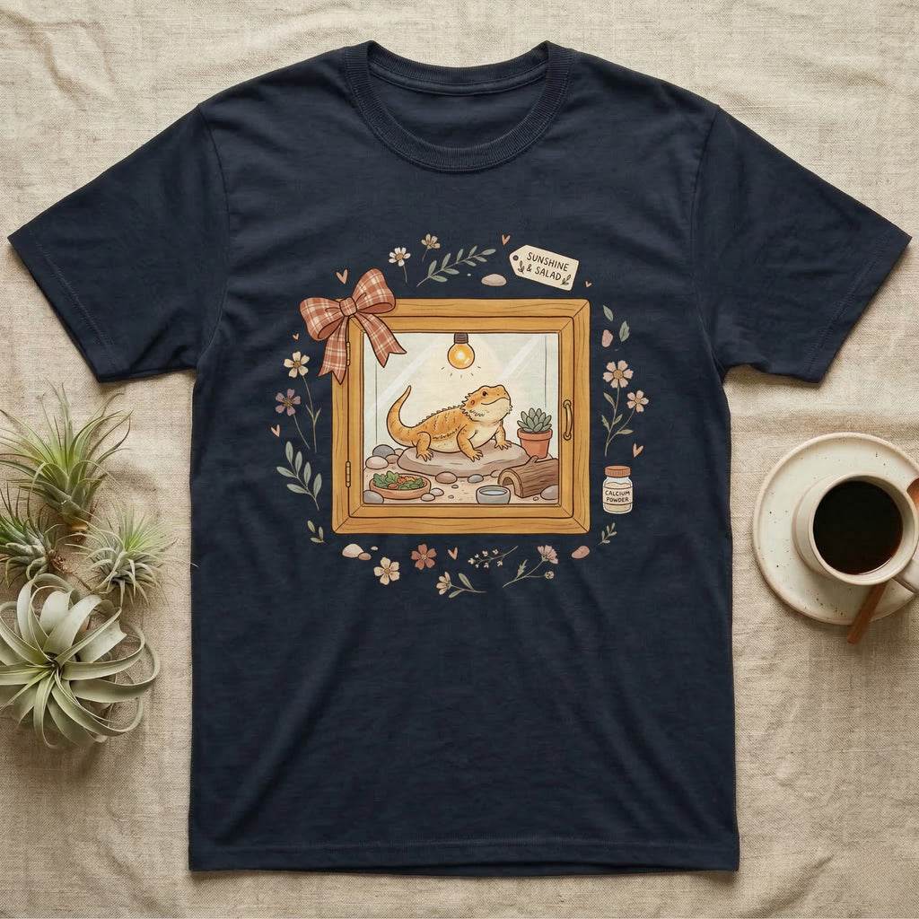 Navy t-shirt with a cartoon bearded dragon in a terrarium setting.