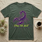 Dark green t-shirt with neon purple scorpion graphic and text "STING THE BEAT".