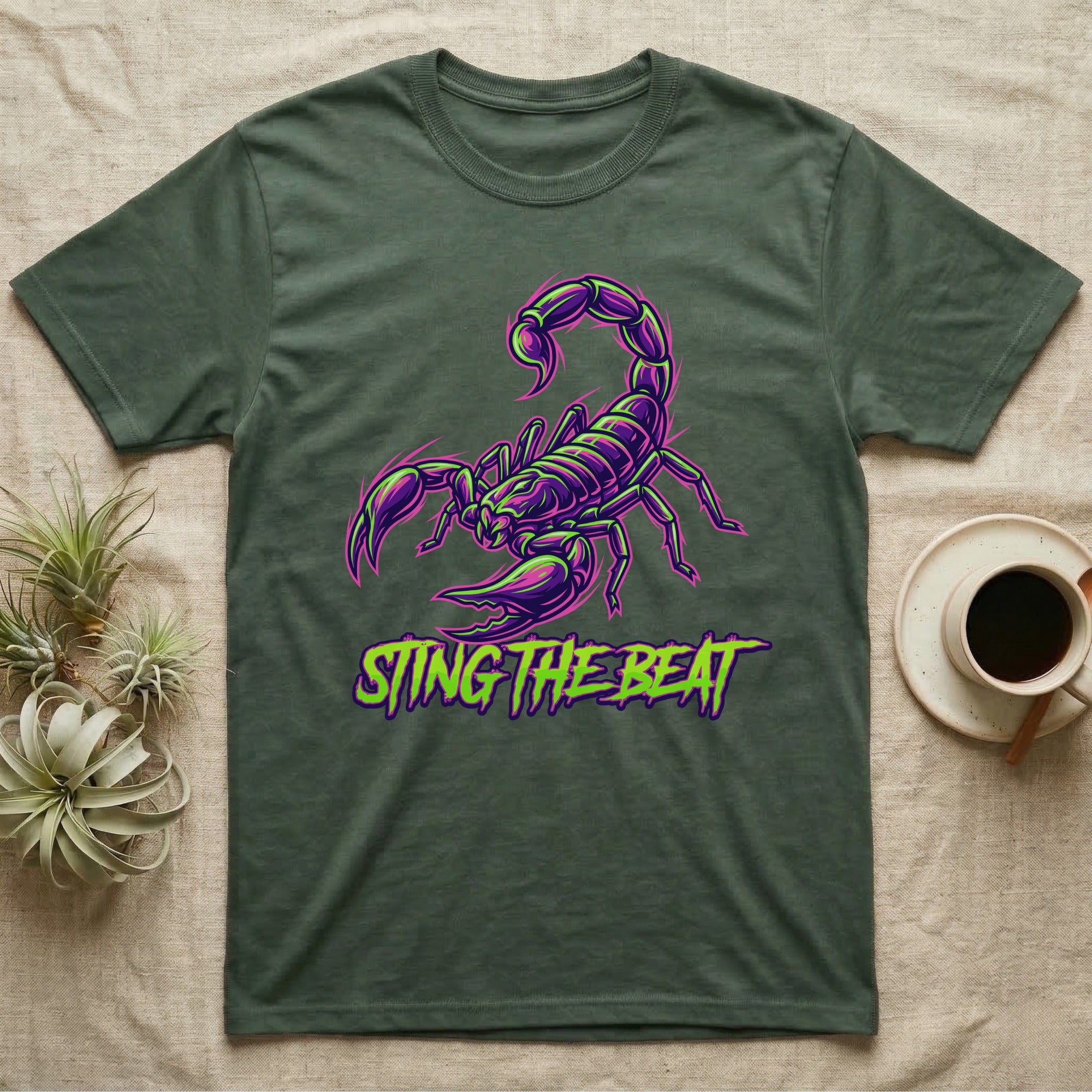 Dark green t-shirt with neon purple scorpion graphic and text "STING THE BEAT".