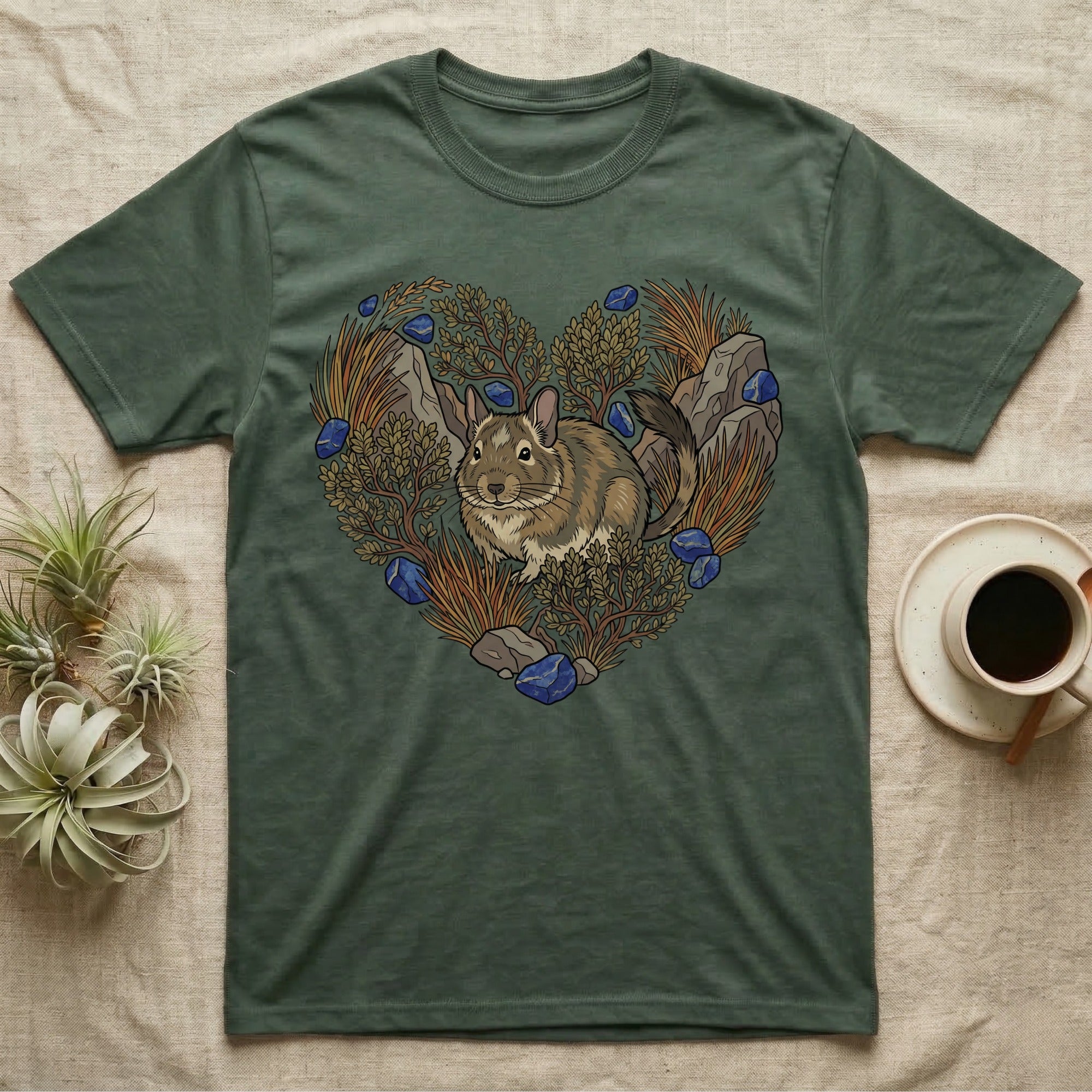 Green t-shirt with a heart-shaped design featuring a chinchilla, rocks, and foliage.