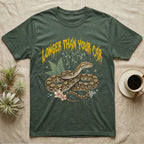 Reticulated Python Feral T-Shirt in Military Green — Reticulated python in net-patterned coils under jagged molten-gold metal text LONGER THAN YOUR CAR with pastel ferns