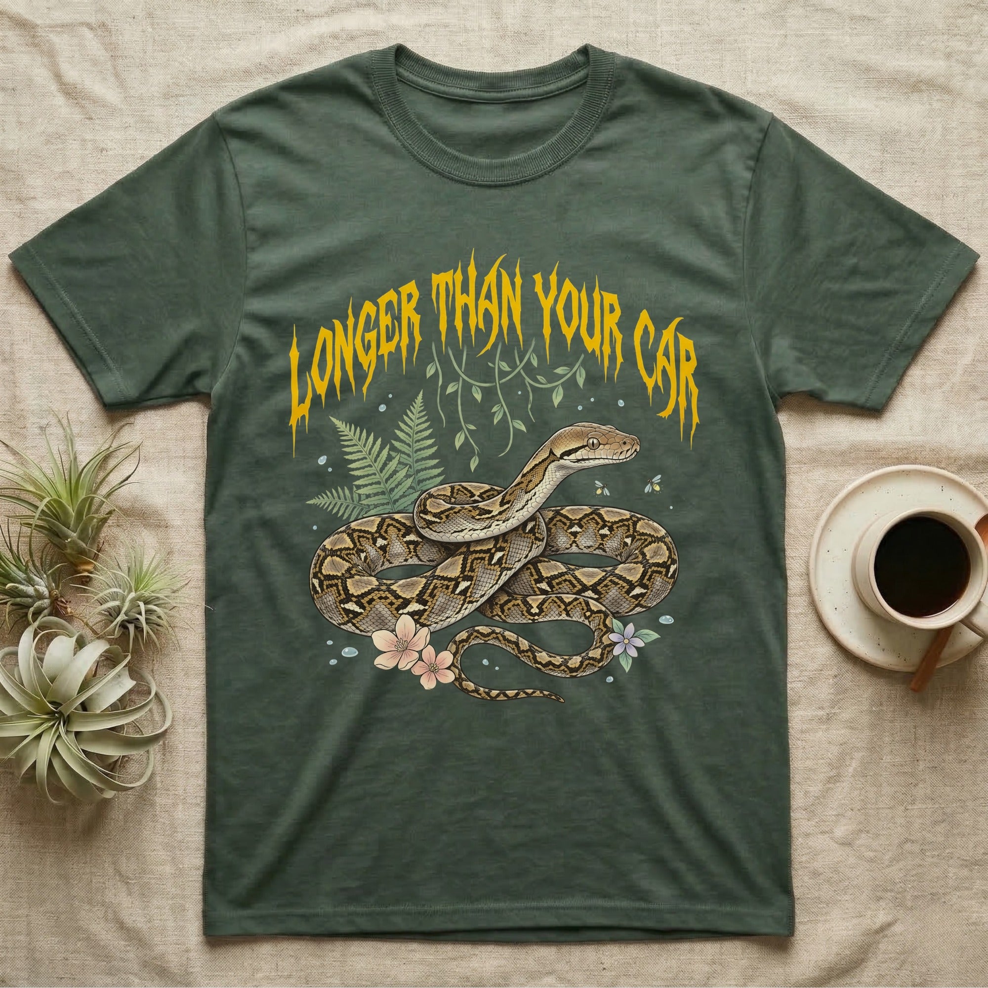 Reticulated Python Feral T-Shirt in Military Green — Reticulated python in net-patterned coils under jagged molten-gold metal text LONGER THAN YOUR CAR with pastel ferns