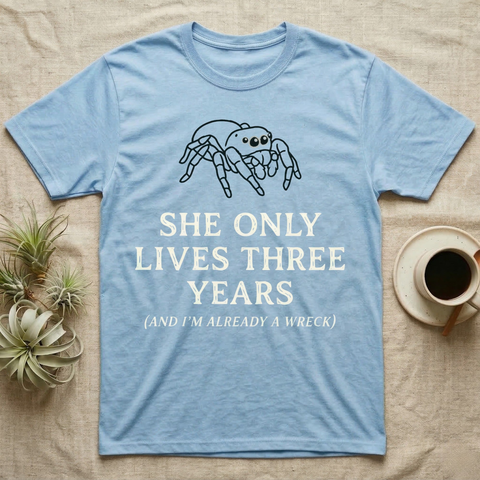 Jumping Spider Three Years Tee in Light Blue — Vintage-ink Phidippus jumping spider portrait above type "She Only Lives Three Years (And I'm Already A Wreck)."