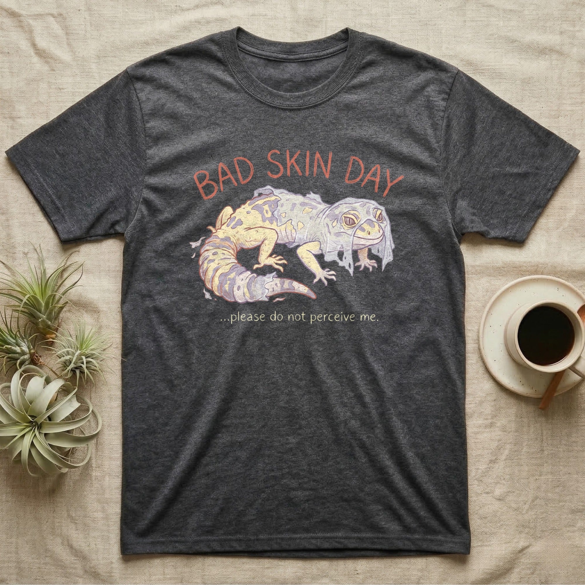 Dark t-shirt with "BAD SKIN DAY" and a shedding leopard gecko illustration.