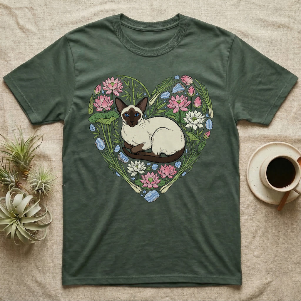 Green t-shirt with Siamese cat illustration surrounded by lotus flowers and water plants.