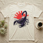 Cream t-shirt with a stylized black scorpion against a red sun and waves.