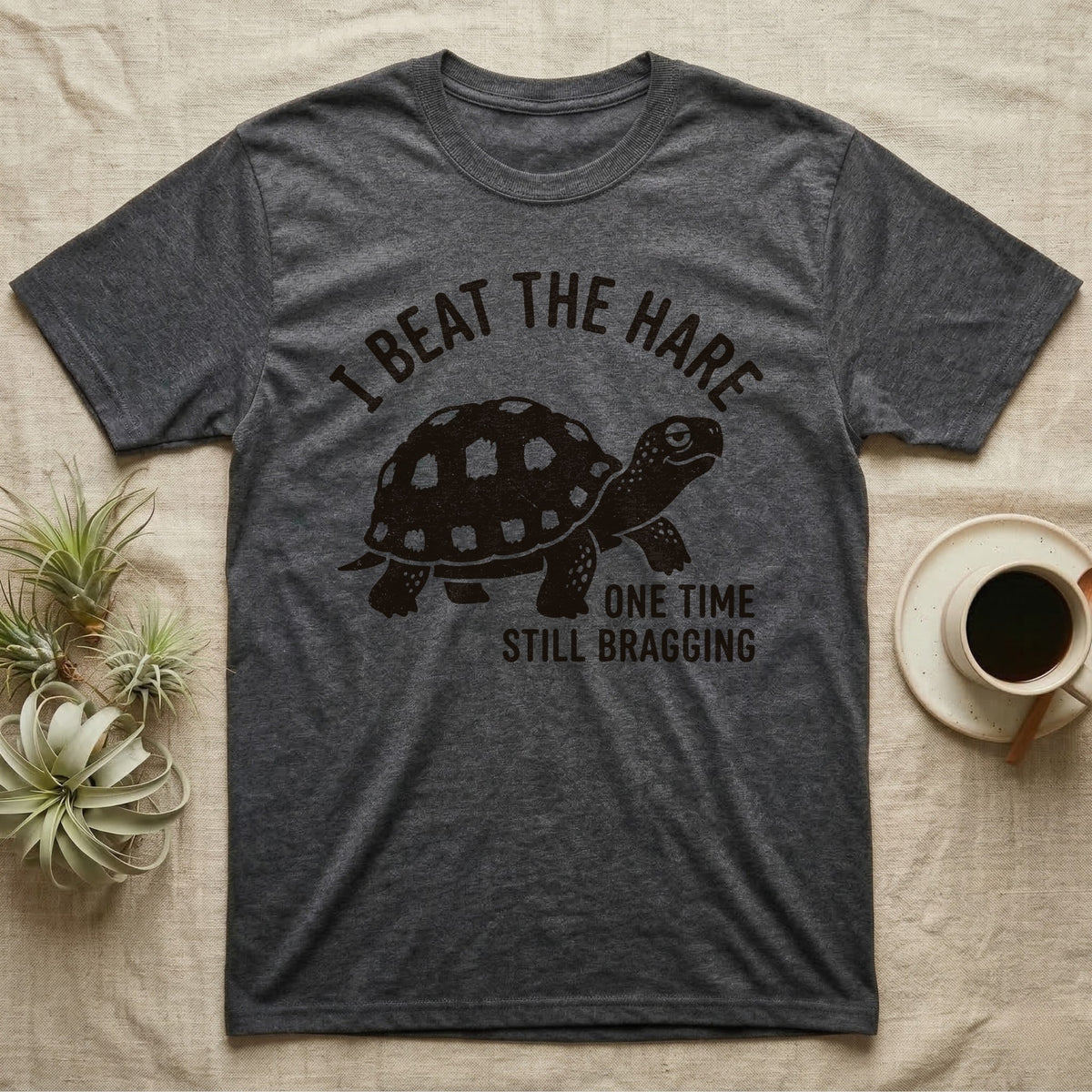 Red-Foot Tortoise Bragging T-Shirt in Dark Heather — Smug red-footed tortoise walking chin-up under I Beat the Hare, One Time, Still Bragging