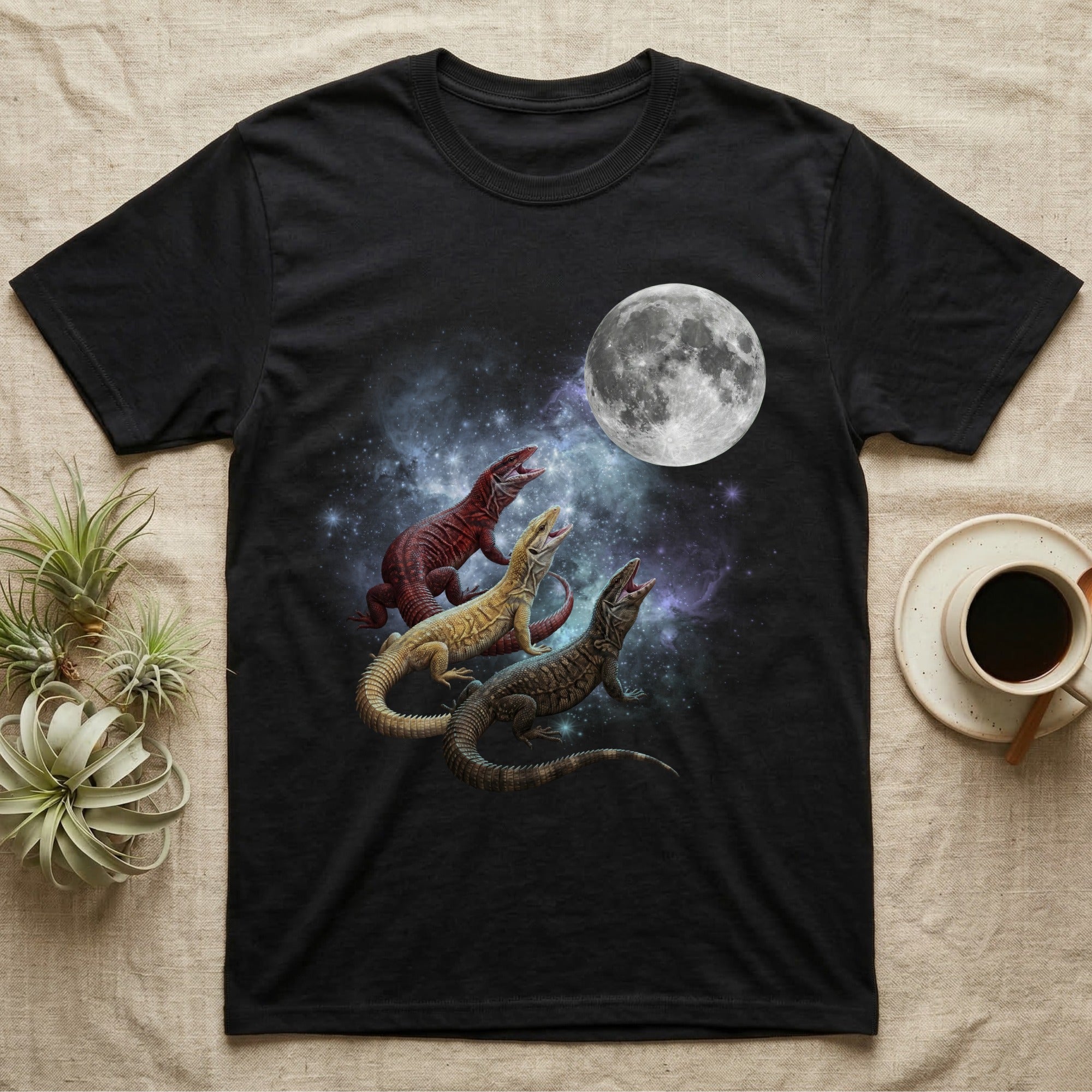 Ackie Monitor Moon Howl T-Shirt in Black — Three Ackie Monitor colour morphs howling at a full moon over a nebula on a dark grey t-shirt.