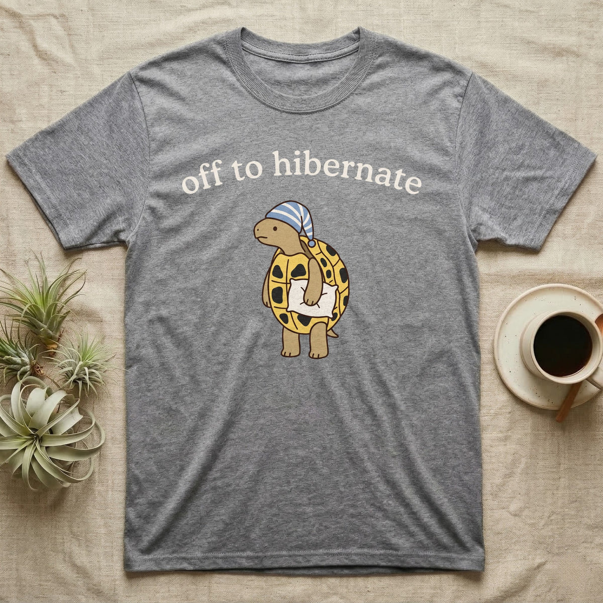 Hermann's Tortoise Hibernation T-Shirt in Sport Grey — Minimal doodle of a Hermann's tortoise in a striped nightcap holding a pillow under the words off to hibernate
