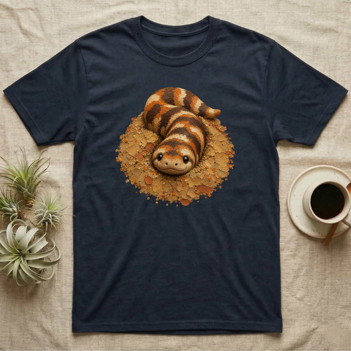 Dark blue t-shirt featuring a cartoon snake emerging from a nest.