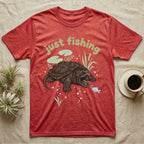 Alligator Snapping Turtle Softie T-Shirt in Heather Red — Alligator snapping turtle with open mouth and tongue lure under a puffy pastel "just fishing" bubble wordmark.