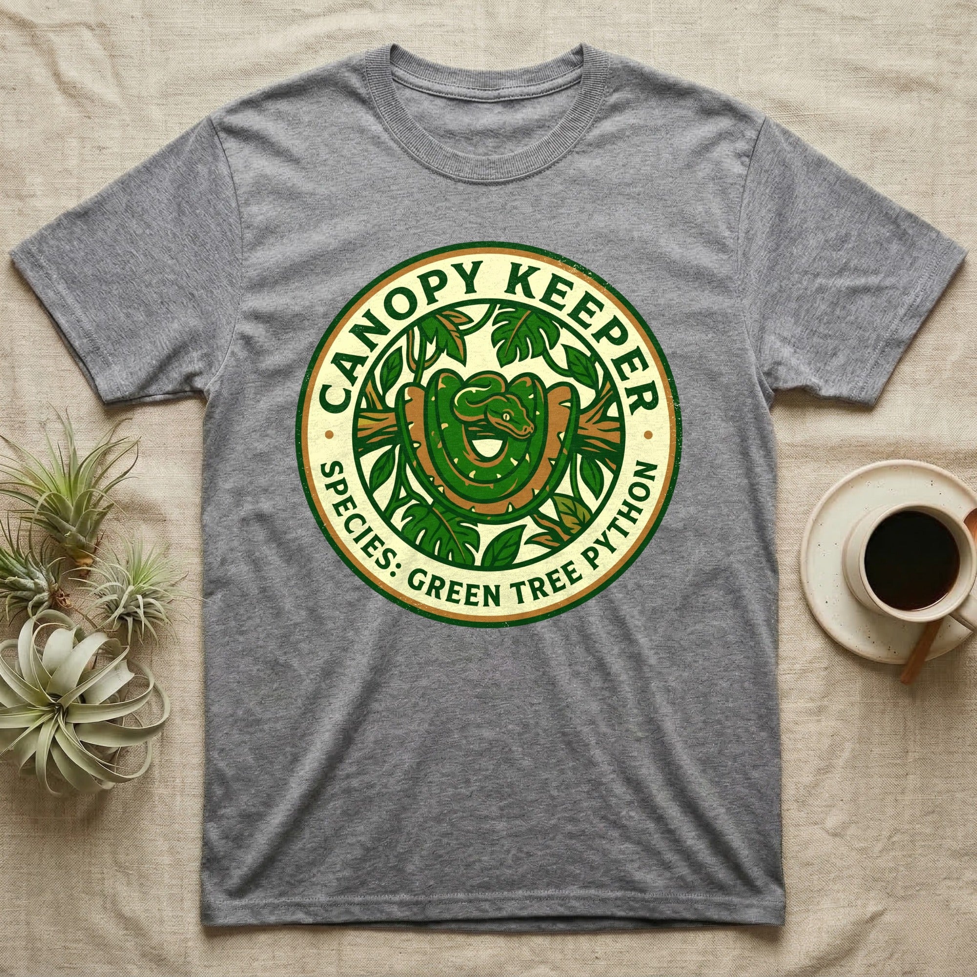 Grey t-shirt with "Canopy Keeper Species: Green Tree Python" circular logo.