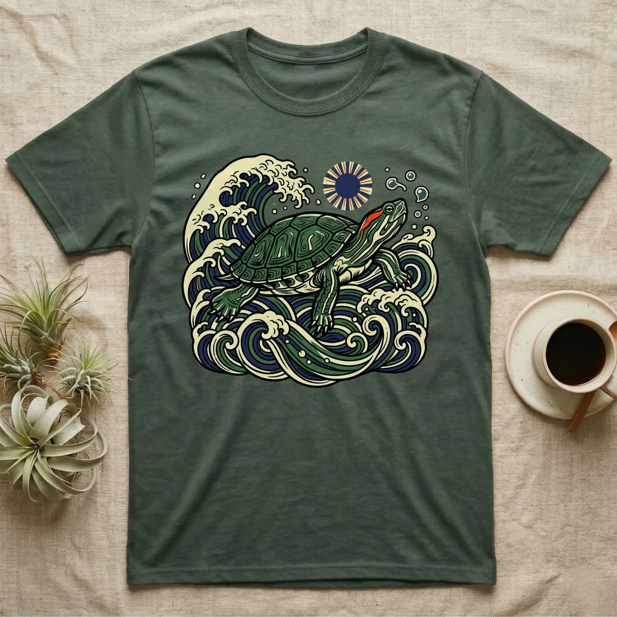 Green t-shirt with a graphic of a turtle in stylized ocean waves.