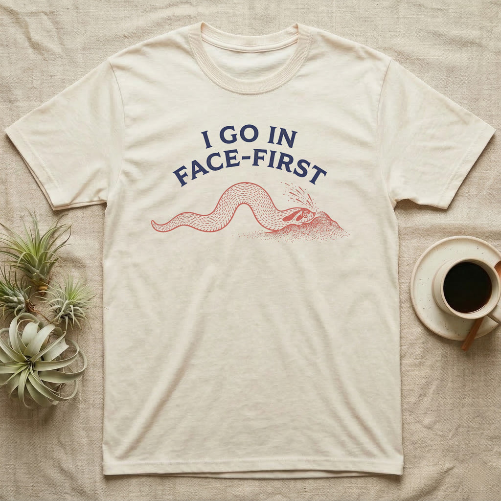 Western Hognose Face-First T-Shirt in Natural — Two-ink worn-stamp print of a western hognose snake digging head-first into a mound of sand beneath arched text reading I GO IN FACE-FIRST.