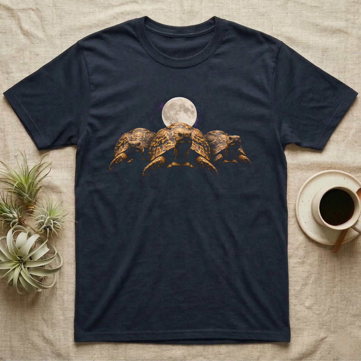 Leopard Tortoise Moon T-Shirt in Navy — Three leopard tortoises facing out under a full moon and nebula, dissolving into black.
